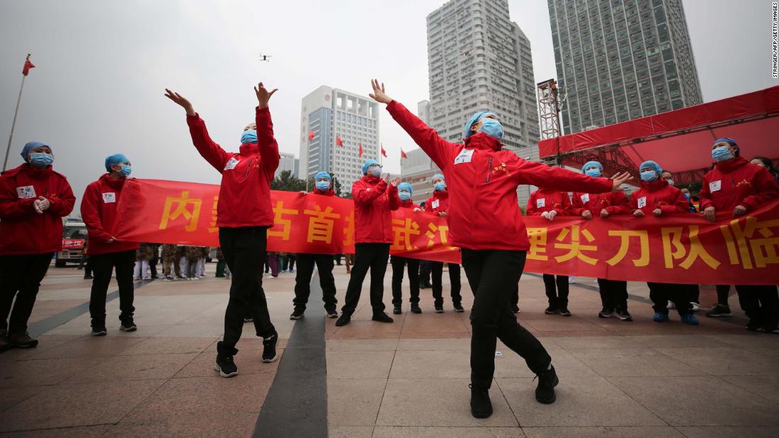 Medical staff in Wuhan, China, celebrate after all coronavirus patients were discharged from a temporary hospital on March 9.