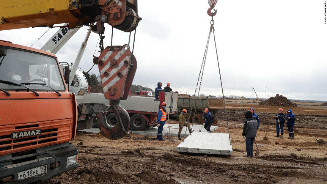 Workers prepare to construct an additional building on a hospital on the outskirts of Moscow.