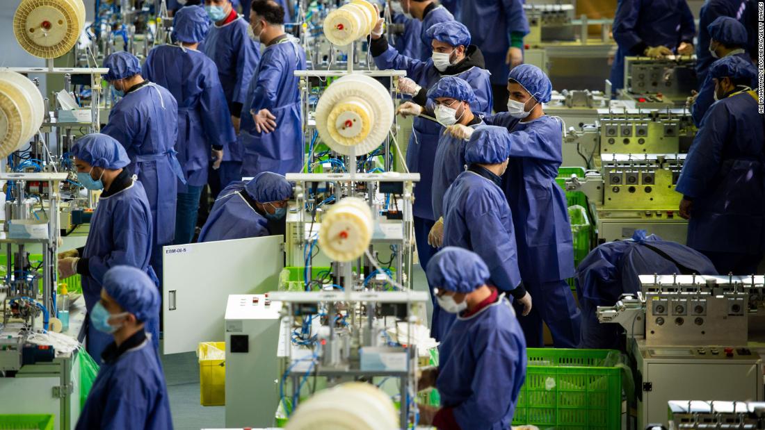 Workers produce protective face masks at a new factory near Tehran, Iran, on April 14.